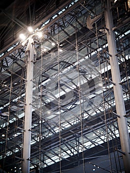 Indoor modern contemporary complex steel wall and roof construction structure inside a large building with bright illumination hig