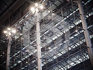 Indoor modern contemporary complex steel wall and roof construction structure inside a large building with bright illumination hig