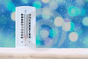 Indoor and Outdoor Thermometer that Shows a very low temperature on Fahrenheit and Celsius with defocus background and falling