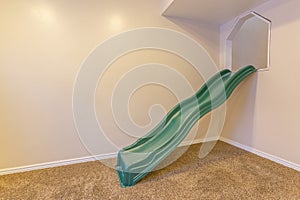 Indoor playground with slide against a white wall