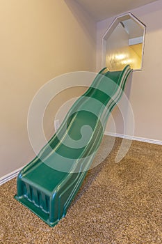 Indoor playset with slide in a white walled room