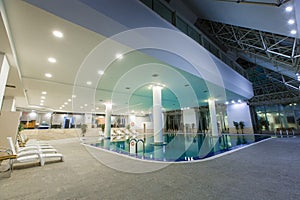 Indoor pool in the hotel, chaise lounges