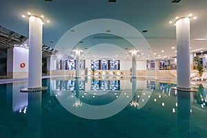 Indoor pool in the hotel, chaise lounges