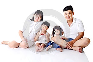 Indoor portrait of asian family sitting on the floor