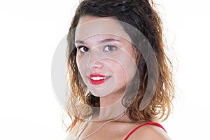 Indoor portrait of beautiful brunette young curly woman smiling