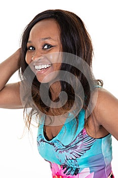 Indoor portrait of beautiful brunette young dark-skinned woman smiling cheerfully showing white teeth to camera feeling happy