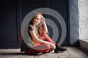 Indoor portrait of beautiful young redhead woman