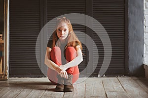 Indoor portrait of beautiful young redhead woman