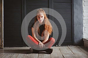 Indoor portrait of beautiful young redhead woman