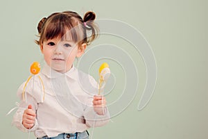 Indoor portrait of cute happy baby girl playing with easter decorations