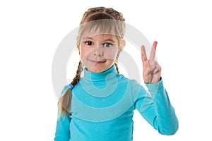 Indoor portrait of European girl isolated on white background with optimistic smile, showing victory sign looking