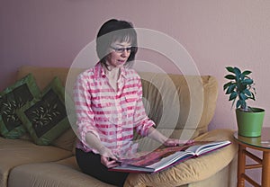 Indoor portrait of smiling middle age woman in checked shirt