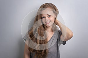 Indoor portrait of smiling pretty beautiful attractive caucasian woman girl with long wavy hair