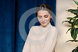 indoor portrait. Young beautiful woman in warm knitted clothes at home. fashion