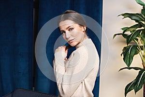 indoor portrait. Young beautiful woman in warm knitted clothes at home. fashion