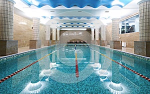 Indoor public swimming pool interior in fitness gym club