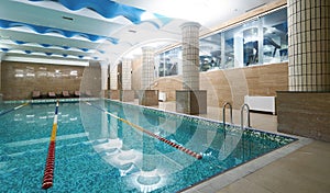 Indoor public swimming pool interior in fitness gym club