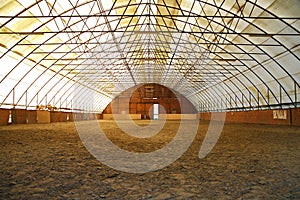 Indoor riding arena covering sand for trainings photo