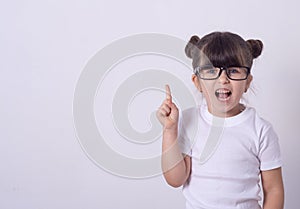 Indoor shot of friendly young girl laughing and smiling joyfully raising hands