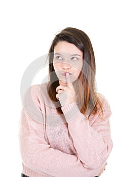 Indoor shot of thoughtful pretty young woman looks aside with pensive expression plans something poses against blank white wall