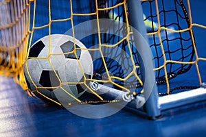 Indoor Soccer Futsal Ball On Goal With Net And Blue Background. Indoor Football Background photo