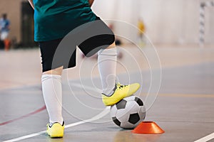 Indoor soccer player training with balls. Indoor soccer sports hall. Football futsal player, ball, futsal floor