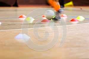 Indoor soccer player training with a white futsal ball. Futsal training dribbling drill