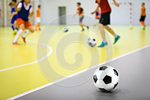 Indoor soccer training class for children. Soccer skills training. Futsal players in practice game