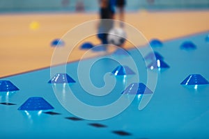 Indoor soccer training during the winter. Futsal training field with blue cones