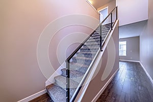 Indoor staircase against brown wooden floor and plain white wall of home