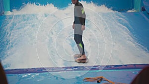 Indoor surf sports club for children. Theme is active recreation and extreme sports on water. Student and coach on