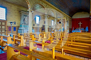 Indoor view of wooden made church in Chonchi, Chiloe island in Chile. Nuestra Senora del Rosario photo