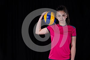 Indoor young volleyball woman player isolated on dark background