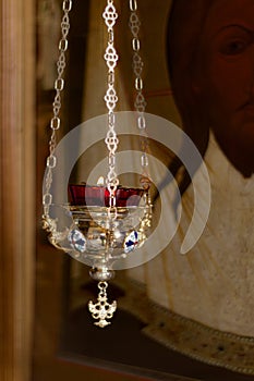 Icon lamp in front of icon in Orthodox Church. Indoors, day light Front view photo