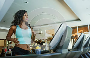 Indoors fitness center lifestyle  portrait of young attractive and sweaty black African American woman training hard at gym doing