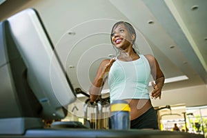 Indoors fitness lifestyle  portrait of young attractive and happy black afro American woman training hard at gym all sweaty doing