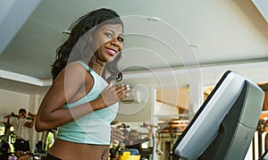 Indoors fitness lifestyle  portrait of young attractive and happy black afro American woman training hard at gym all sweaty doing