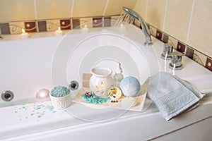 Indoors home spa toiletries on tray in bath room on bath.