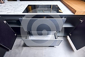 Induction cooker black glass hob with integrated hood or aspirating induction hob on marble light stoneware countertop photo