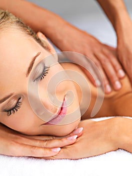 Indulging in some blissful me time. A beautiful young woman relaxing in a spa - massage therapy.