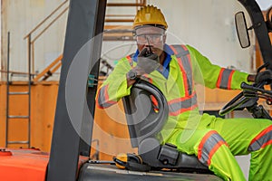 Industial background of african american forklift driver driving forklift a loading area at containers yard and cargo