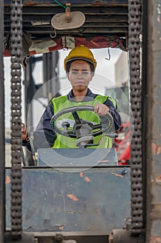 Industial background of african american forklift driver driving forklift a loading area at containers yard and cargo