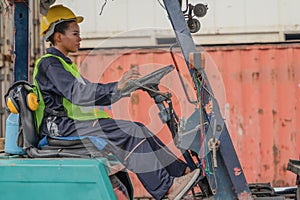 Industial background of african american forklift driver driving forklift a loading area at containers yard and cargo photo
