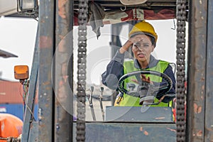 Industial background of african american forklift driver driving forklift a loading area at containers yard and cargo photo