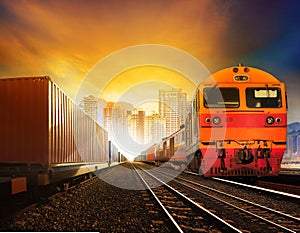Industindustries container trainst and boxcar on track against b