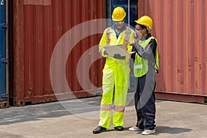 Industrail background of african american containers yard and cargo inspector team working at containers loading area