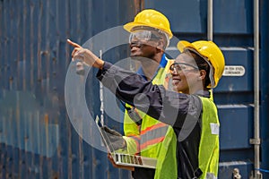 Industrail background of african american containers yard and cargo inspector team working at containers loading area