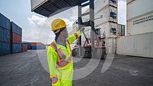 Industrail background of african american containers yard and cargo inspector working at containers loading area