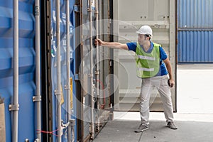 Industrail background of caucasian containers yard and cargo inspector working at containers loading area