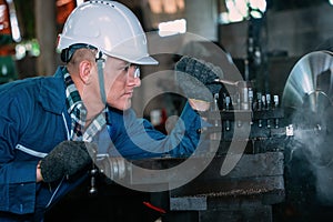 Industrail background of caucasian mechanics engineer operating lathe machine for metalwork in metal work factory